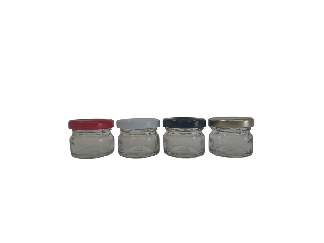 4 row of 4x 28ml glass jars, each with a different colour lid. Black, gold, red and white.